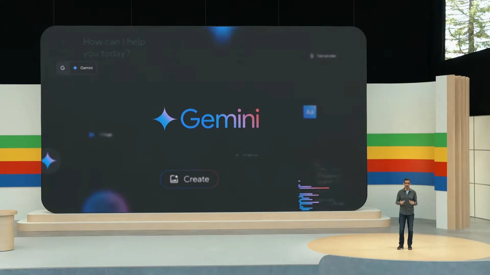 ステージの背後に「Gemini」と書かれたスライドが表示されている写真